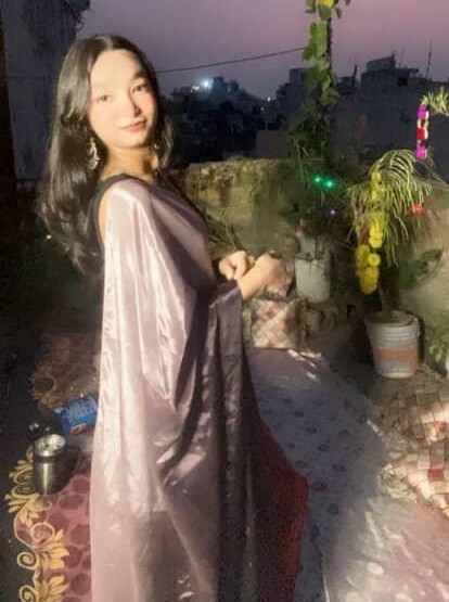 Tanya in a flowing lavender saree on a rooftop at twilight