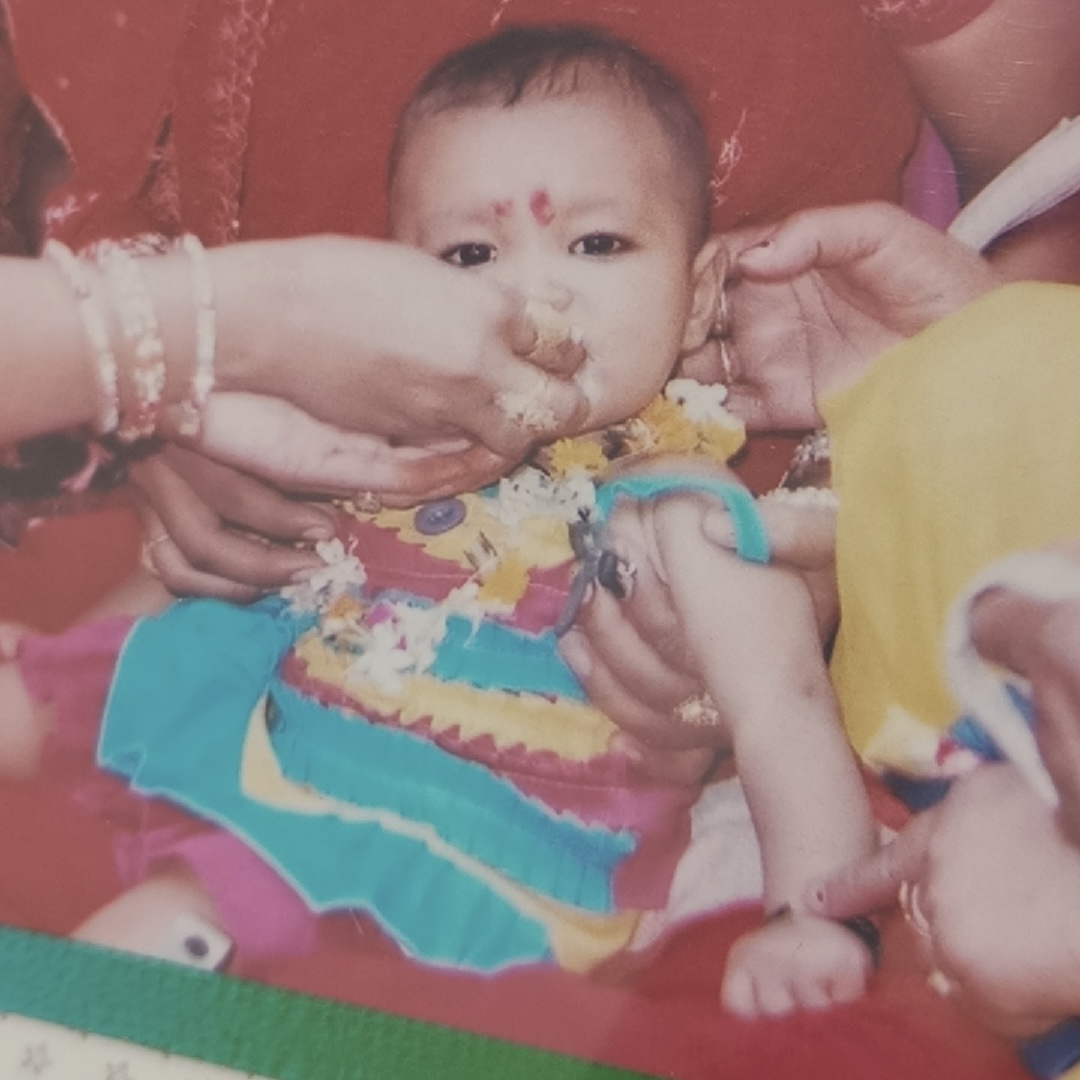 Baby Tanya being fed sweets at a celebration